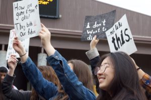 Students at the walkout held signs that advocated for gun control or expressed anti-Trump sentiment. Photo by Hallie Olson.